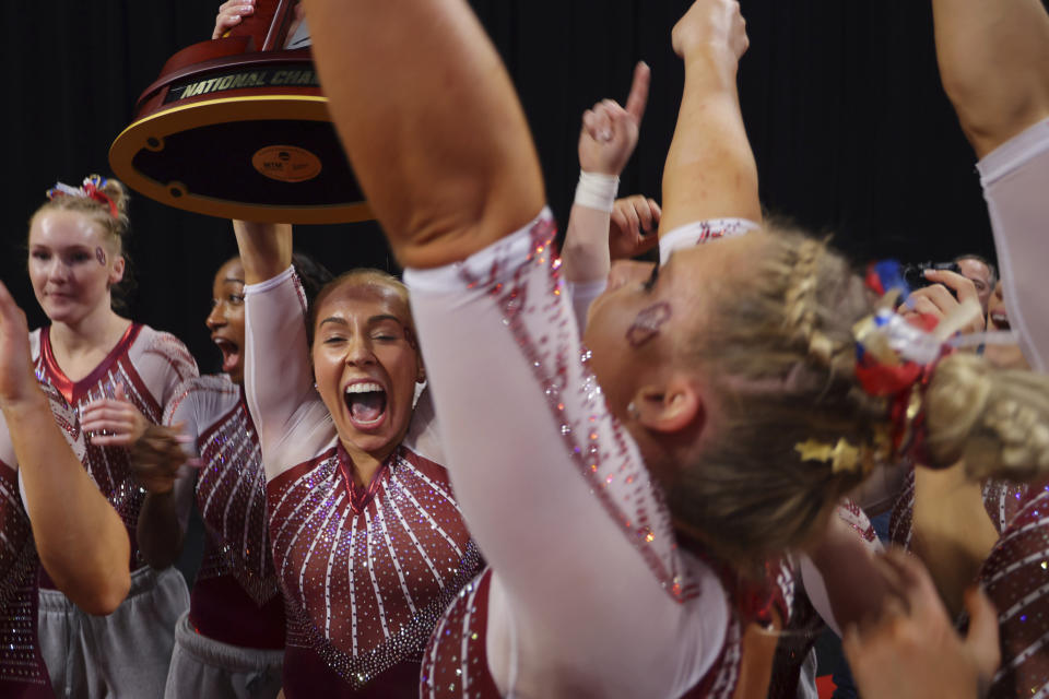 Oklahoma team celebrates their victory together after the NCAA college women's gymnastics championships, Saturday, April 16, 2022, in Fort Worth, Texas. (AP Photo/Gareth Patterson)