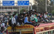 NEW DELHI, INDIA - MARCH 28: A huge rush of migrant workers who had been marching to their homes, seen at Anand Vihar Bus Terminal on day 4 of the nationwide lockdown to check the spread of coronavirus, on March 28, 2020 in New Delhi, India. (Photo by Biplov Bhuyan/Hindustan Times via Getty Images)