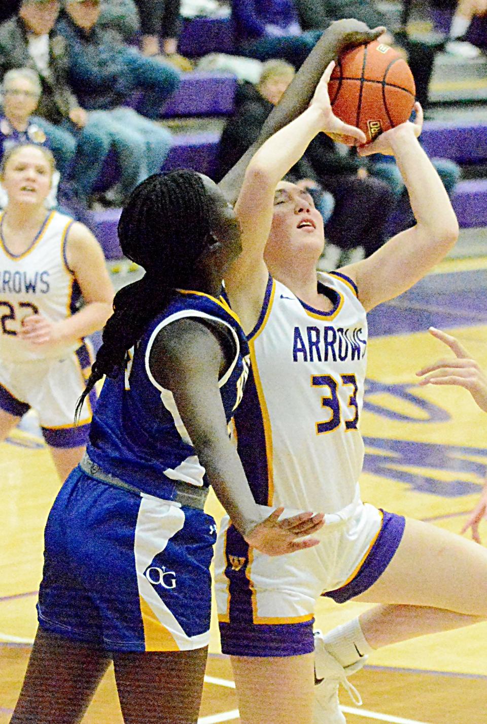 Watertown's Avery Munger puts up a shot against Sioux Falls O'Gorman's Aweng Akoi during their high school girls basketball game Friday night in the Civic Arena. O'Gorman won 50-42. Akoi was whistled for a foul on the play.