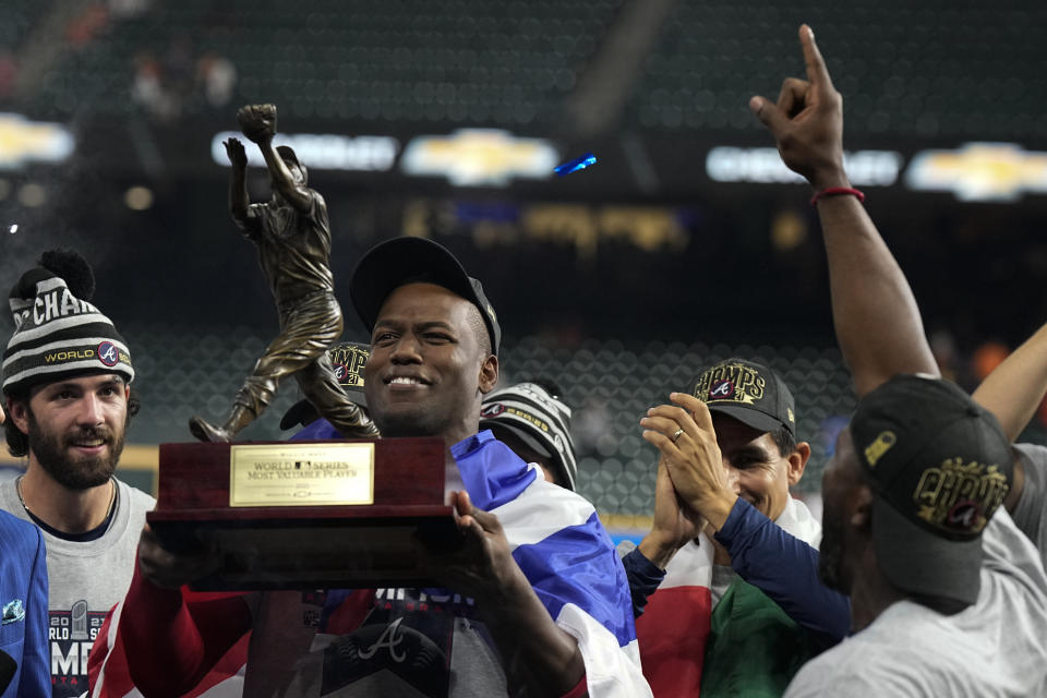 Atlanta Braves designated hitter Jorge Soler holds up the MVP trophy after winning baseball's World Series in Game 6 against the Houston Astros Tuesday, Nov. 2, 2021, in Houston. The Braves won 7-0. (AP Photo/David J. Phillip)