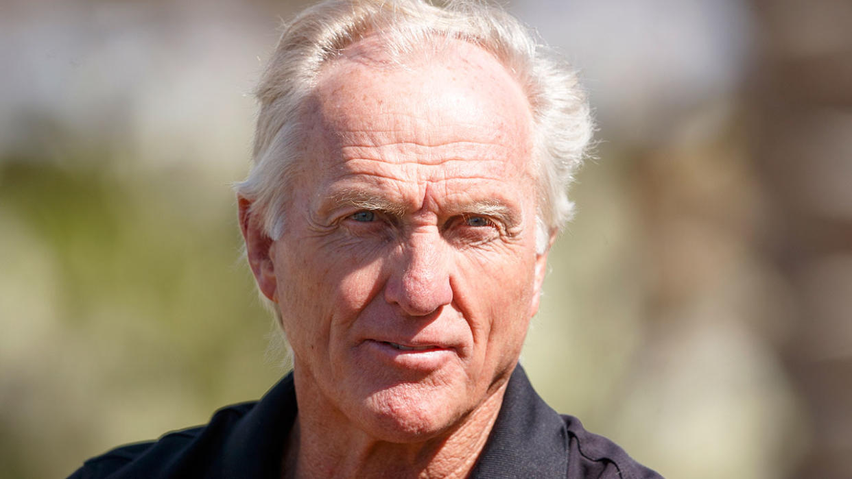 Greg Norman is pictured here posing for a photo by himself.