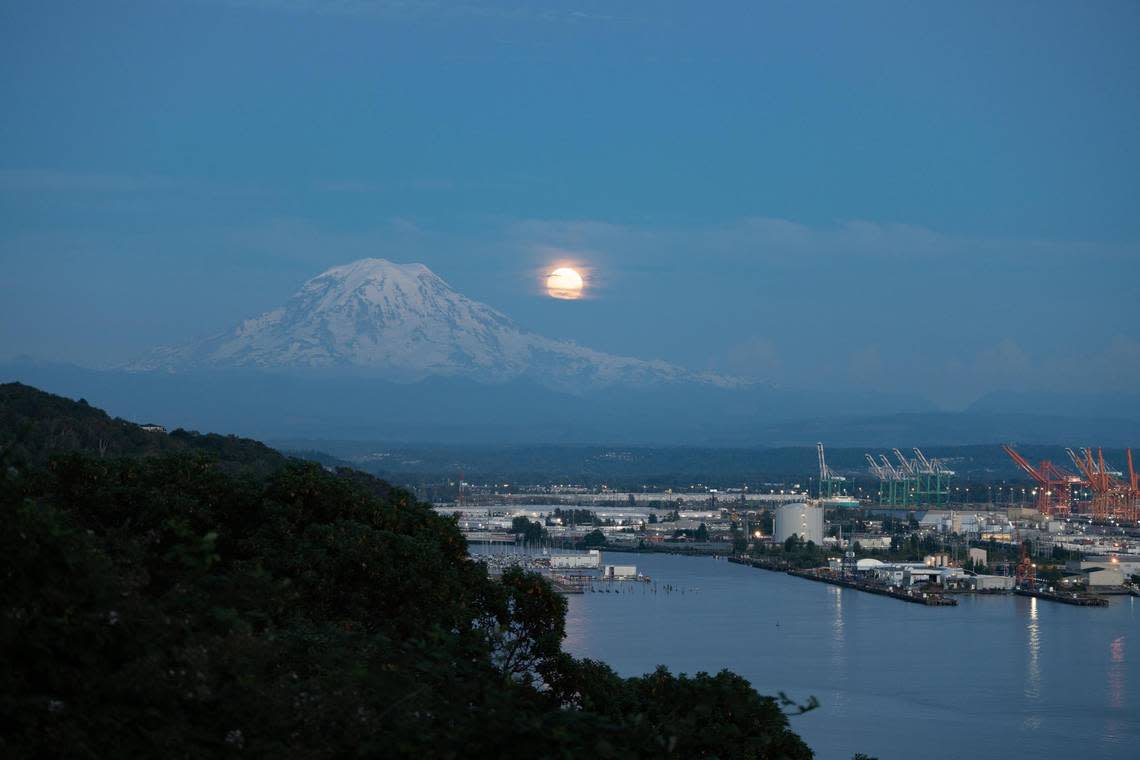 The supermoon rises next to Mt. Rainier on Tuesday July 12, 2022.