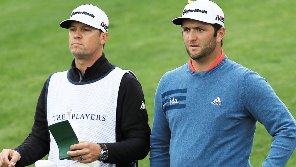 Jon Rahm and his caddie. (Photo by Mike Ehrmann/Getty Images)