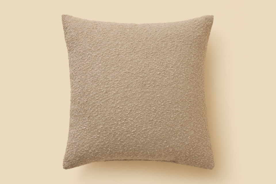 BIG W tan textured cushion on a beige background