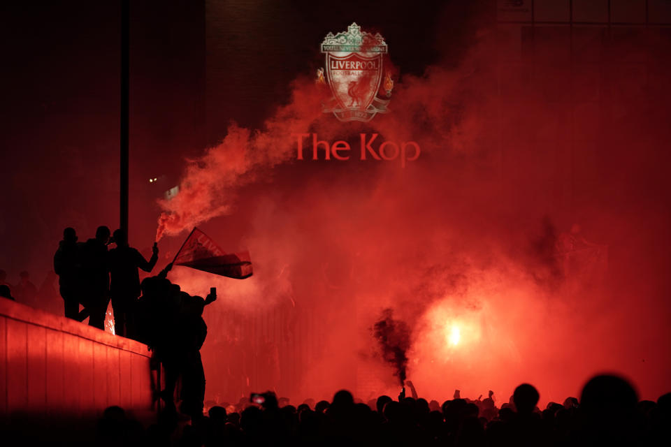 Liverpool fans celebrate outside Anfield stadium as Liverpool lift the Premier League trophy after their match against Chelsea.