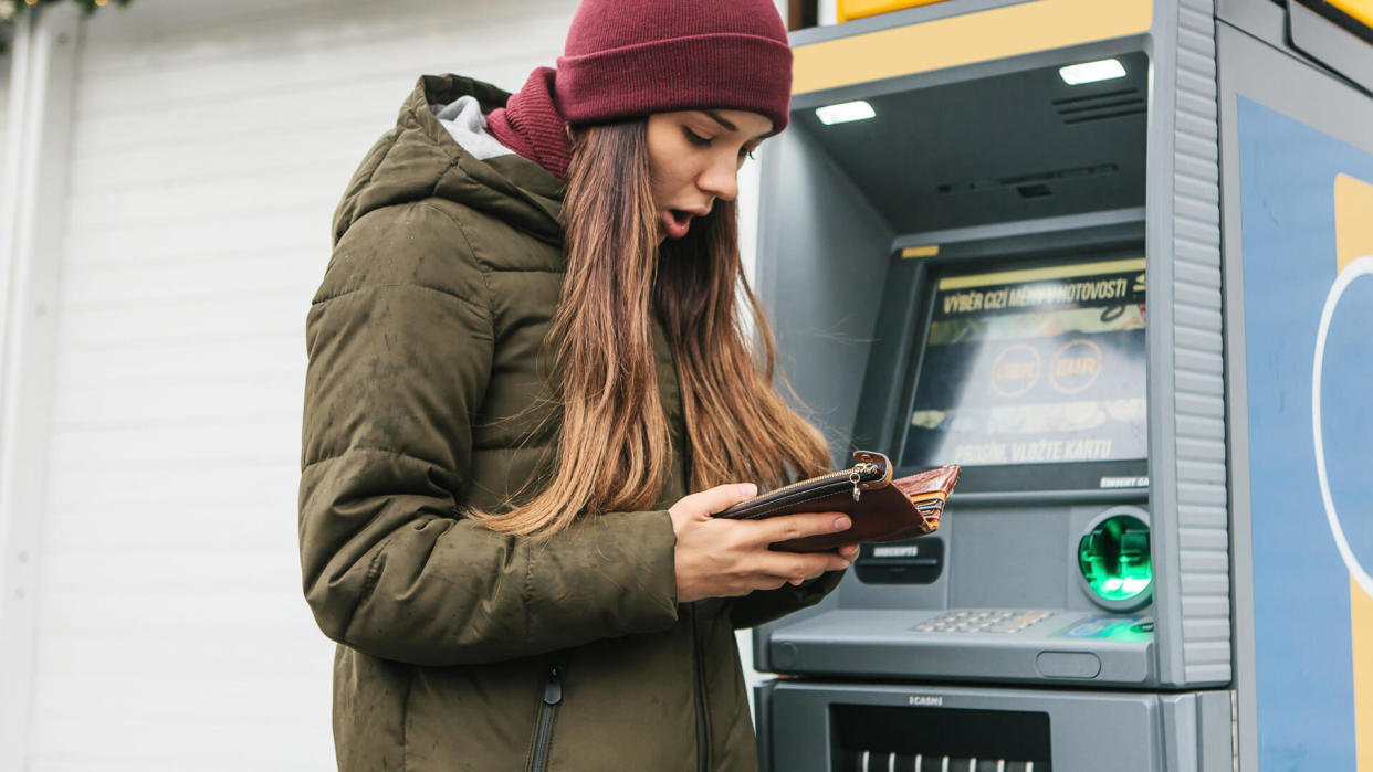 A tourist's girl looks into the purse and sees that she has lost a credit card or she was cheated on money or something else happened that is unpleasant.