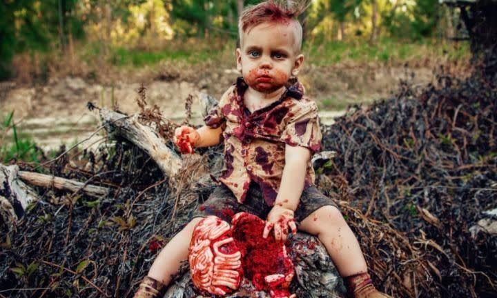 A mum has faces backlash after celebrating her son's first birthday with this zombie cake smash photoshoot. Photo: Amanda Queen Photography