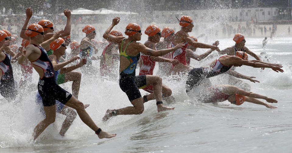 Competitiors enter the water during the women’s triathlon