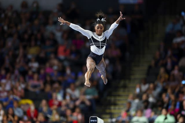 <p>Stacy Revere/Getty Images</p> Simone Biles competes on the balance beam at the Core Hydration Classic on August 5, 2023