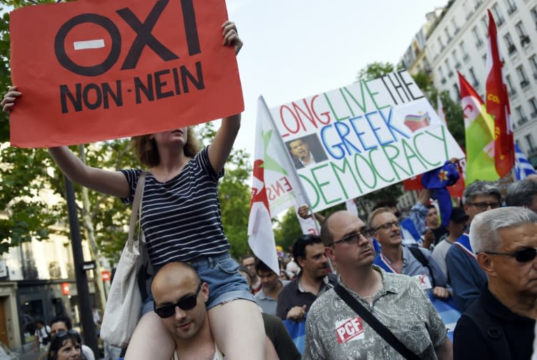 Marchers display banners during a rally in support of the people of Greece in Paris on July 2, 2015