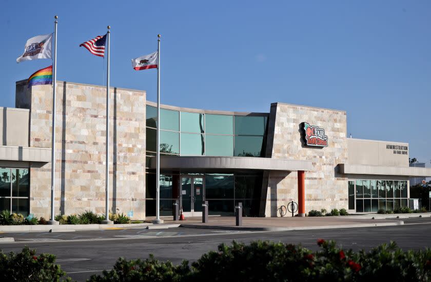 Four flags, including the American, California, OCFEC and the LGBTQ flags, fly over the O.C. Fair & Event Center administration building, in Costa Mesa on Thursday, Nov. 19, 2020. Some locals say it is non-inclusive to have the LGBTQ flag flying without extending the same offer to other area groups and affiliations.