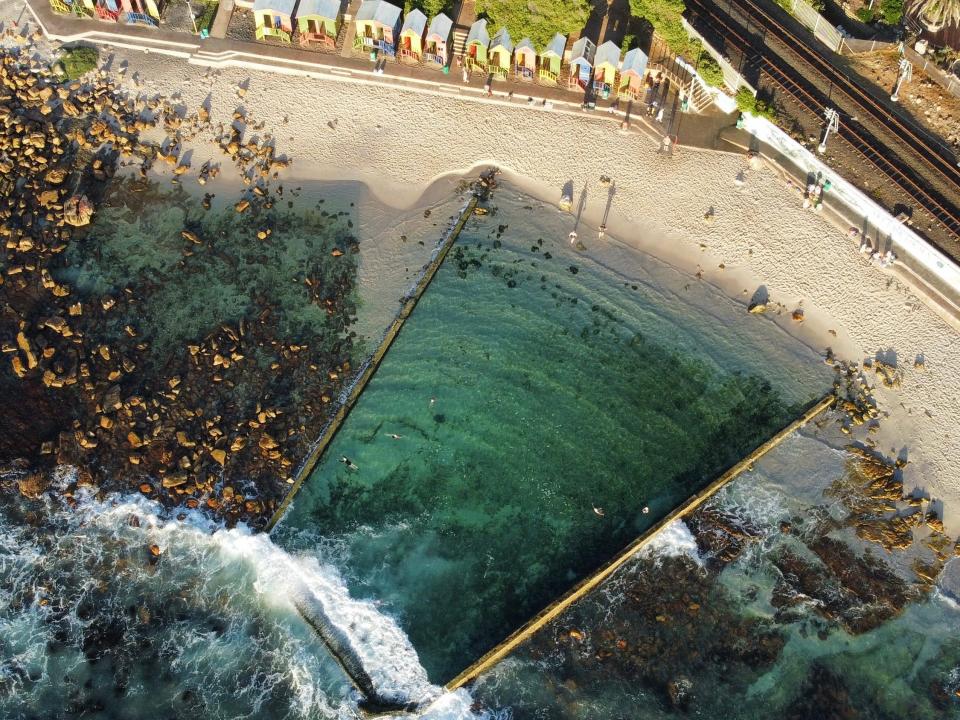 St. James Tidal Pool, a greenish b lue body of wate surrounded by sand