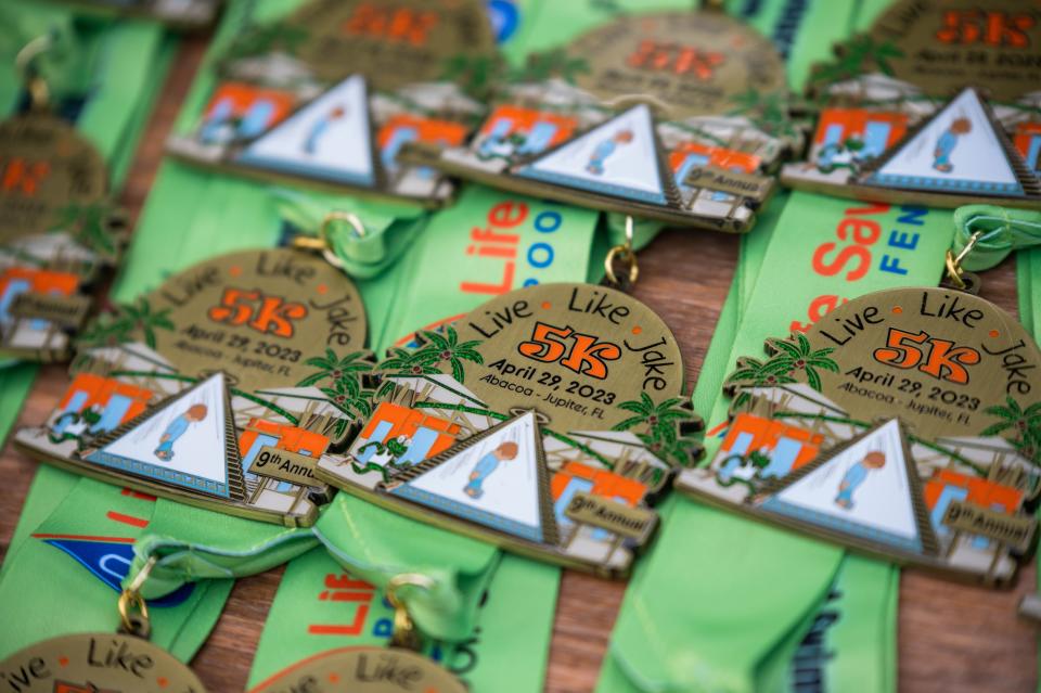 Medals lie on a table before being awarded during the ninth annual Live Like Jake 5K, held Saturday in the Abacoa community in Jupiter. drowning accident in 2013.