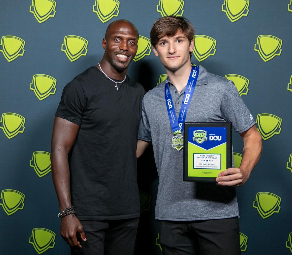 Nashoba's Dillan Lowe poses with former New England Patriots safety Devin McCourty in June after being named T&G Hometeam Boys' Hockey Player of the Year at the Central Mass. High School Sports Awards at the Hanover Theatre.