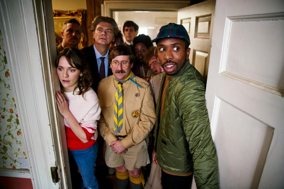 Young couple Alison (Charlotte Ritchie, left front) and Mike (Kiell Smith-Bynoe, right front) inherit an estate filled with ghosts including scout leader Pat (Jim Howick, center front).
