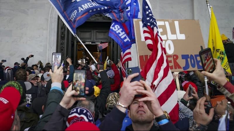 In this Jan. 6, 2021 file photo, Trump supporters gather outside the U.S. Capitol in Washington. Six Capitol Police officers are being disciplined for their actions that day, including posing for photos with participating rioters. (AP Photo/John Minchillo, File)