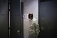 In this July 31, 2020 file photo, a health worker waits for a patient to be tested for COVID-19 at a Primary Health Care Center in Sant Sadurní d'Anoia, Catalonia region, Spain. Spain's improved testing capacity makes a comparison to the start of the pandemic difficult. In February, March and April, a shortage of tests meant that only the very sick who were admitted to hospitals were tested and that a significant number of coronavirus cases went undetected. (AP Photo/Felipe Dana)