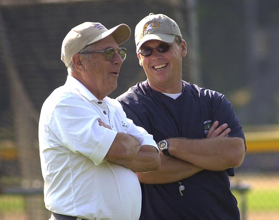 Lee Owens, right, is seen speaking with College Football Hall of Fame Coach and Former Ashland University head coach Fred Martinelli during Ashland University's preseason football practice at Sarver Field during August 2004, his first year as the head coach at Ashland University. FILE PHOTO/TOM E. PUSKAR/ASHLAND TIMES-GAZETTE