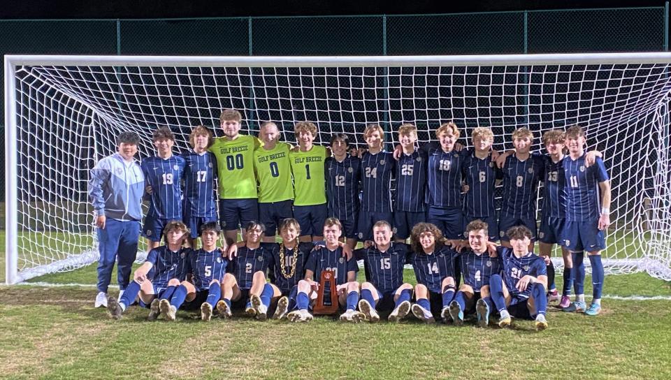 The Gulf Breeze boys soccer team poses for photos after defeating Tate 1-0 for the District 1-6A title on Wednesday, Feb. 1, 2023 from Ashton Brosnaham Park.