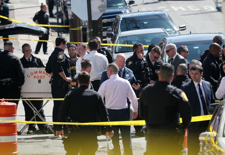 Several Yonkers police officers converge on the intersection of Elm Street and Linden Street in the Nodine Hill section of Yonkers, following a police involved shooting April 20, 2022. 