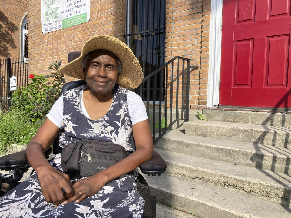 Sonia St. Cyr, a 74-year-old New Orleans resident who uses an electric wheelchair, poses for a photo on July 21, 2022, outside the Broadmoor Community Church where she volunteers at a food pantry. The church is part of a program being launched to put solar panels and batteries on locations around southeastern Louisiana so they can maintain power and help people in their communities such as St. Cyr during extended power outages like the one that followed Hurricane Ida last year. (AP Photo/Rebecca Santana)