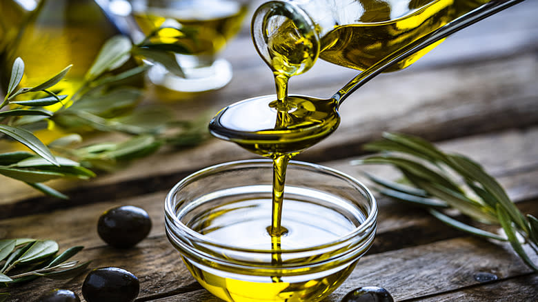 Bottle pouring olive oil