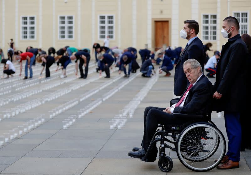 FILE PHOTO: Employees of the Prague Castle light candles to commemorate COVID-19 victims in Prague