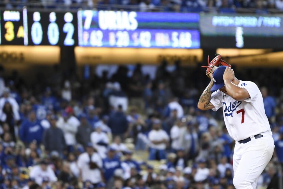 Dodgers pitcher Julio Urias reacts after giving up a hit.