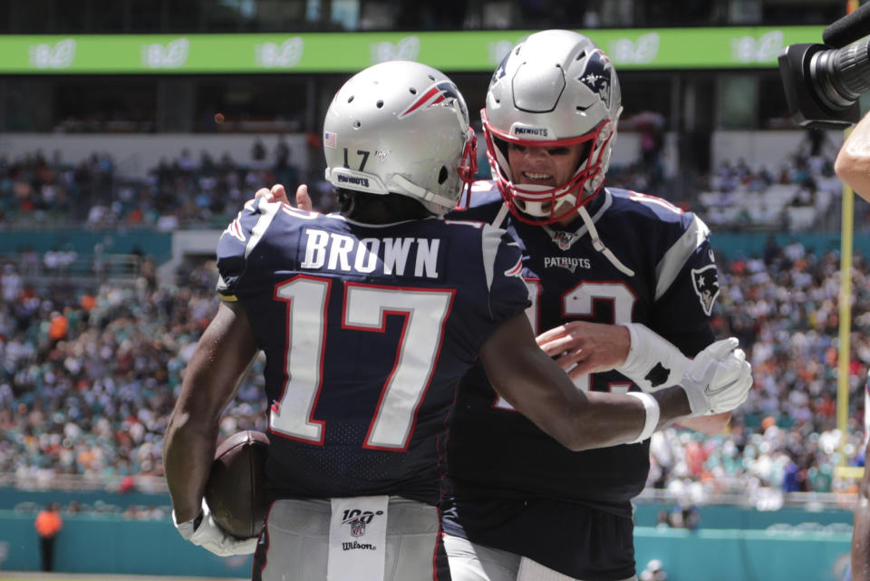 FILE - In this Sept. 15, 2019, file photo, then-New England Patriots quarterback Tom Brady (12) and wide receiver Antonio Brown (17) celebrate after Brown scored a touchdown during the first half at an NFL football game against the Miami Dolphins, in Miami Gardens, Fla. Antonio Brown practices with the Tampa Bay Buccaneers for the first time, Wednesday, Nov. 4, 2020, and is eager to take advantage of his latest opportunity to continue his NFL career. (AP Photo/Lynne Sladky, File)