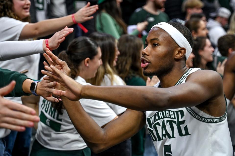 Michigan State's Tre Holloman high fives fans after MSU's win over Maryland on Saturday, Feb. 3, 2024, at the Breslin Center in East Lansing.