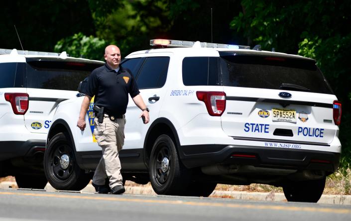 Authorities investigate a mass shooting  that occurred Saturday night at a large house party in Fairfield Township, N.J. near Bridgeton. May 23, 2021.