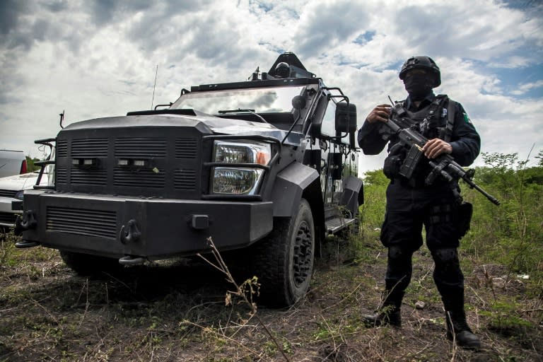 Mexican police participate in an operation to bust a clandestine lab for making synthetic drugs in Carrizalejo, in the state of Sinaloa, in July 2018