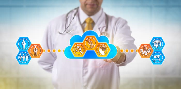 A doctor with his finger on a graphic of cloud-based healthcare services.