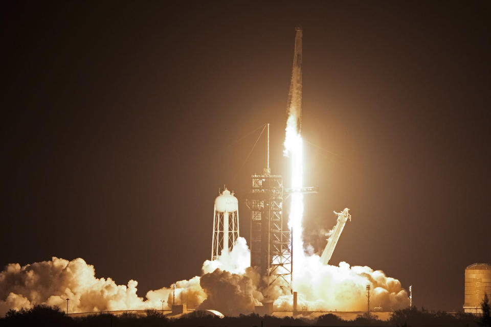 A SpaceX Falcon 9 rocket and Dragon capsule with a crew of four on a mission to the International Space Station lifts off from pad 39A at the Kennedy Space Center in Cape Canaveral, Florida, on Sunday. (John Raoux / AP)