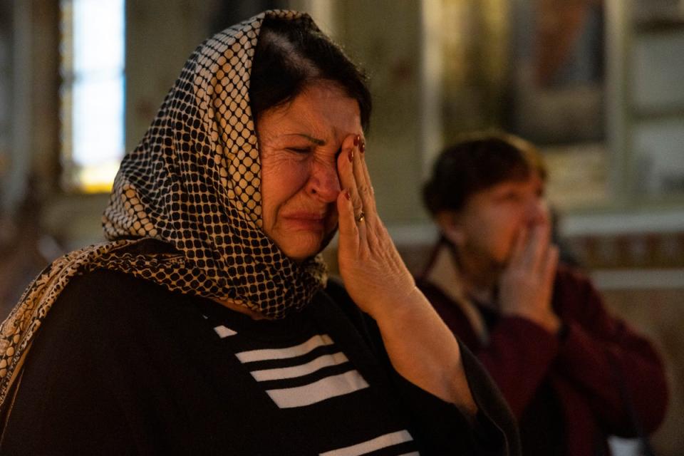 Tetiana cries as she prays during a Sunday afternoon service at the Pokrovsky cathedral in Kharkiv (Getty Images)