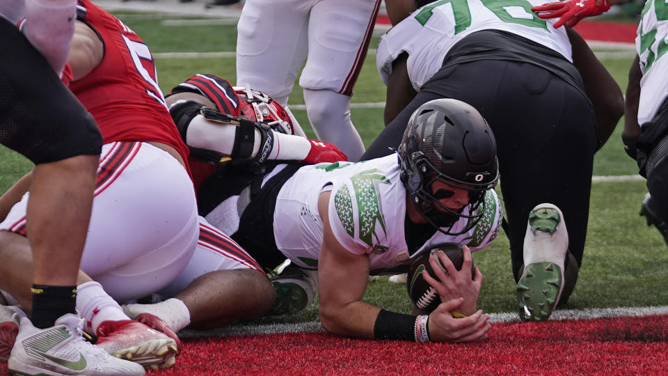 Oregon quarterback Bo Nix (10) scores against Utah on Saturday, Oct. 28, 2023, in Salt Lake City. Nix led a dominant win for the Ducks. (AP Photo/Rick Bowmer)