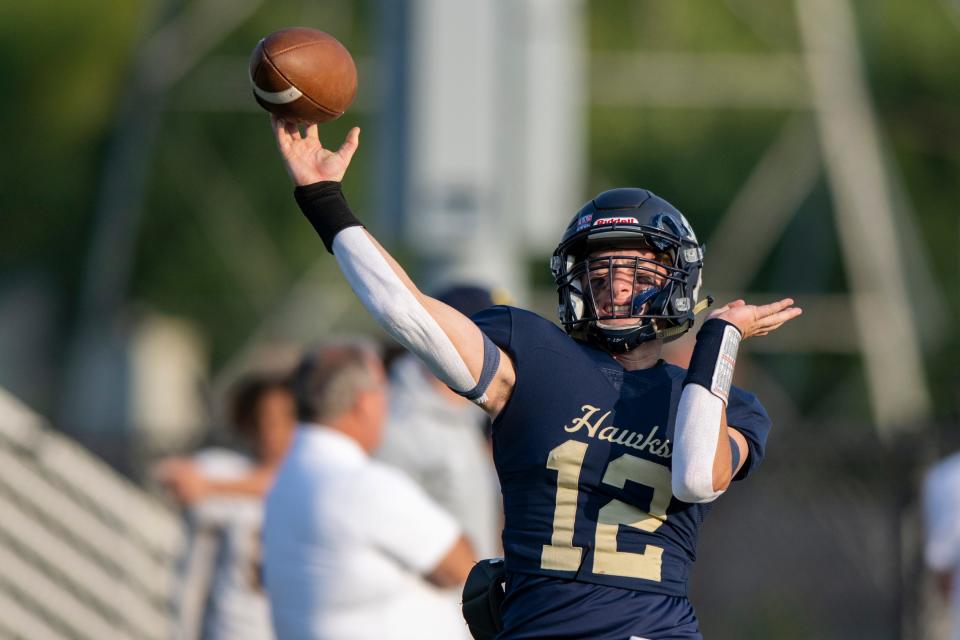 Decatur Central High School freshman Bo Polston (12) warms up on the field before the start of an IHSAA varsity football game against Mooresville High School, Friday, Sept. 16, 2022, at Decatur Central High School.