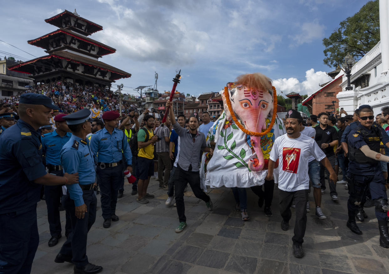 Devotees perform a traditional elephant dance during Indra Jatra, a festival that marks the end of the rainy season in Kathmandu, Nepal, Tuesday, Sept. 17, 2024. (AP Photo/Niranjan Shrestha)