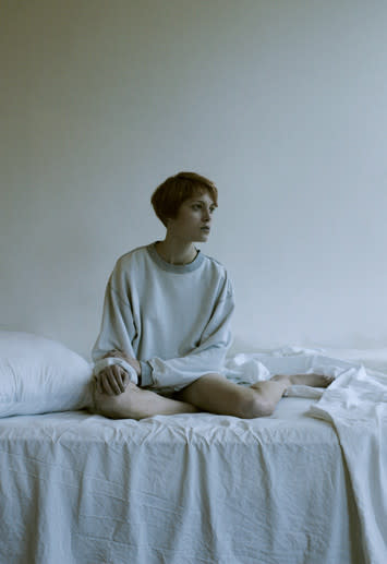 woman sitting on bed