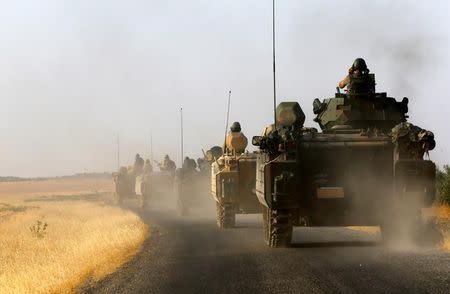 Turkish armoured personnel carriers drive towards the border in Karkamis on the Turkish-Syrian border in the southeastern Gaziantep province, Turkey, August 27, 2016. REUTERS/Umit Bektas