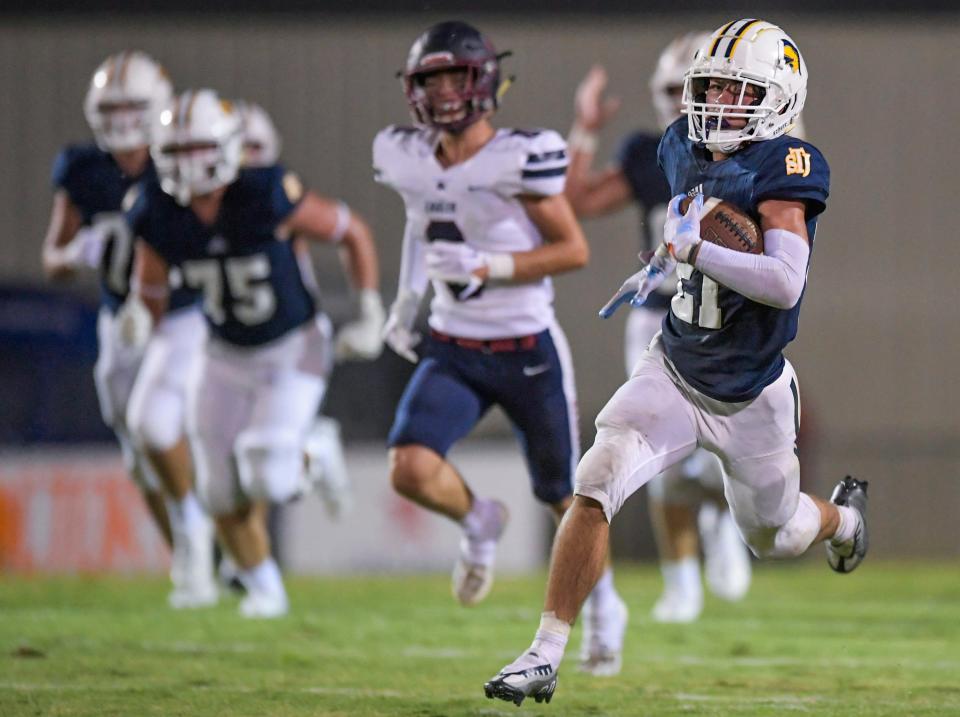 St. James' Cole Anderson (21) scores on a long touchdown against Montgomery Academy during their game on the St. James campus in Montgomery, Ala., on Friday evening August 25, 2023.
