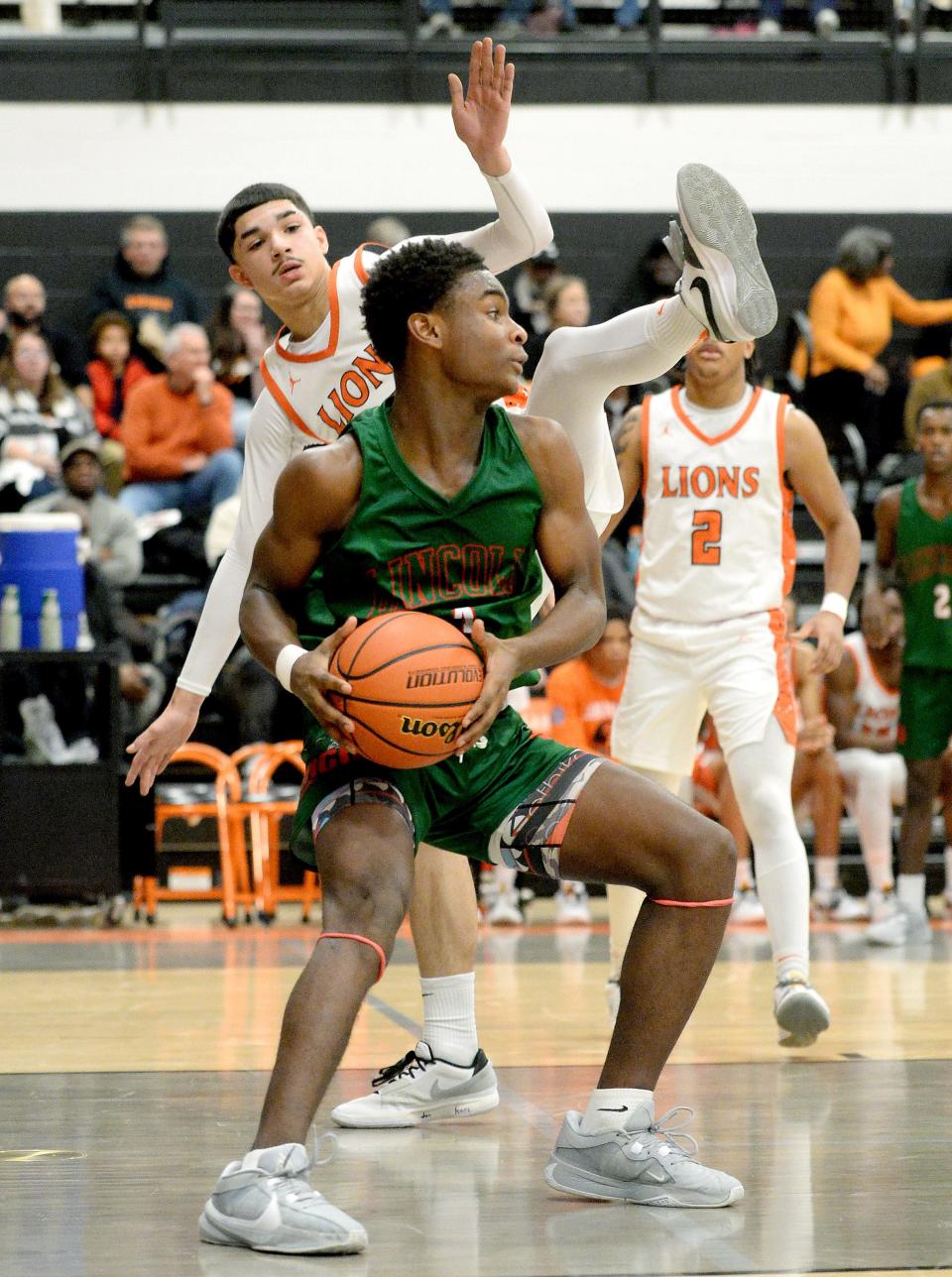 Lincoln's Gabe Smith, front, and Lanphier's Soriano Hayes, back, during the game Friday, January 12, 2024.