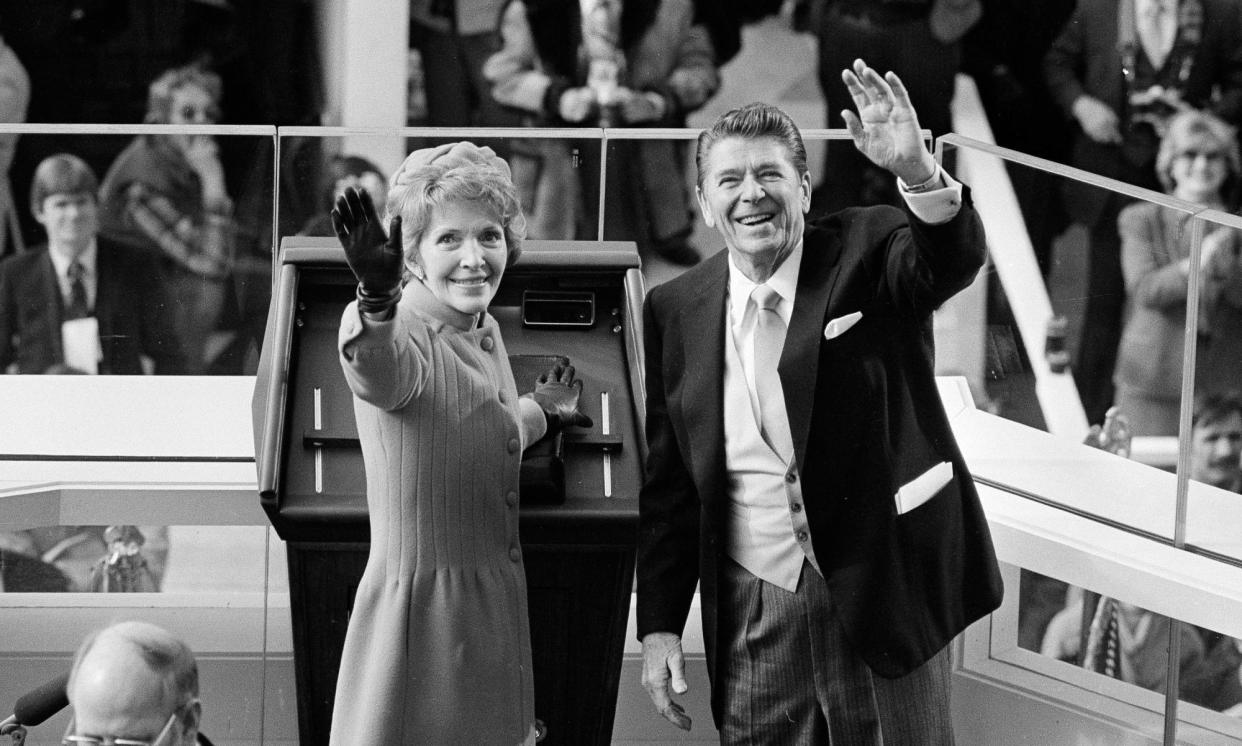 <span>Ronald Reagan and his wife, Nancy, wave to supporters at his inauguration in January 1981.</span><span>Photograph: Anonymous/AP</span>