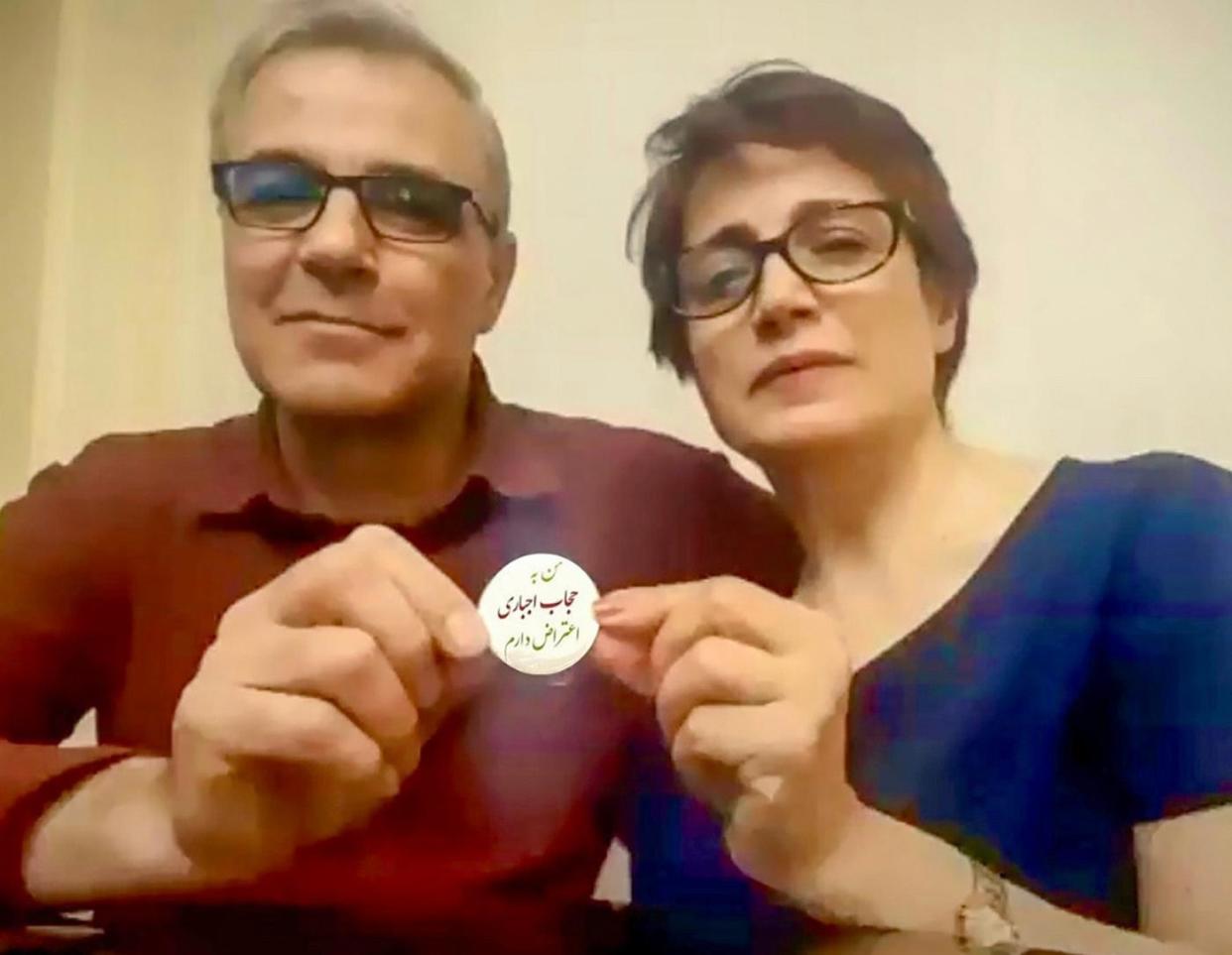 <span>Iranian human rights lawyer Nasrin Sotoudeh and her husband Reza Khandan hold up a protest badge that reads: ‘I oppose the mandatory hijab.’</span><span>Photograph: suplied</span>