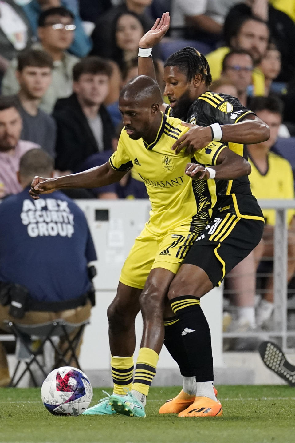 Nashville SC midfielder Fafà Picault, left, tries to get the ball past Columbus Crew defender Steven Moreira, right, during the first half of an MLS soccer match Sunday, May 28, 2023, in Nashville, Tenn. (AP Photo/George Walker IV)