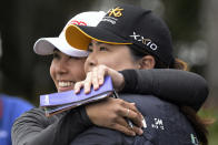 Danielle Kang, left, is congratulated by Inbee Park, of South Korea, on the 18th green after Kang won the Tournament of Champions LPGA golf tournament, Sunday, Jan. 23, 2022, in Orlando, Fla. (AP Photo/Phelan M. Ebenhack)