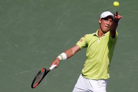 Kei Nishikori serves against John Isner (not pictured) during a men's singles quarter-final on day eleven of the Miami Open at Crandon Park Tennis Center. Isner won 6-4, 6-2. Geoff Burke-USA TODAY Sports