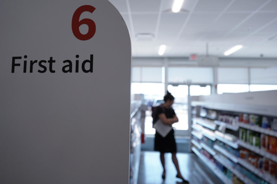 A customer browses the first aid aisle at a Walgreens pharmacy store in Deerfield, Ill., Thursday, July 25, 2024. (AP Photo/Nam Y. Huh)