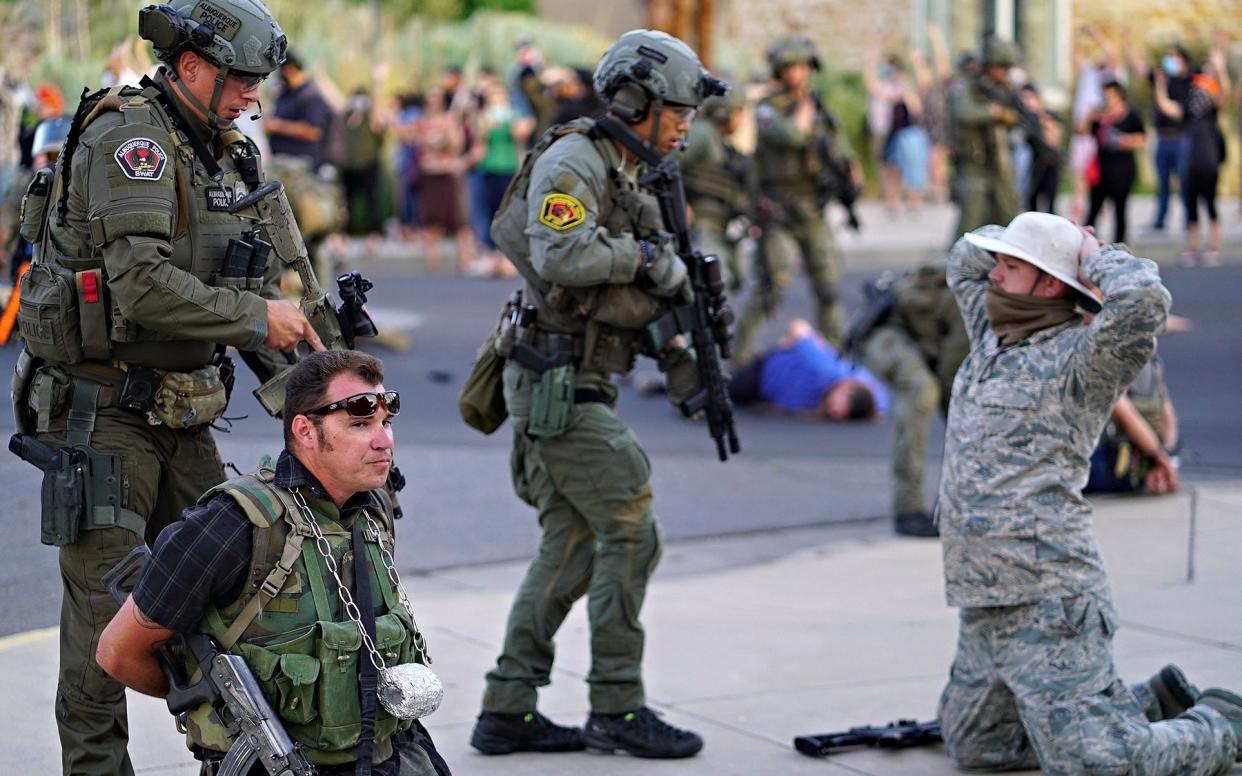 Albuquerque police detain members of the New Mexico Civil Guard, an armed civilian group, following the shooting - The Albuquerque Journal 