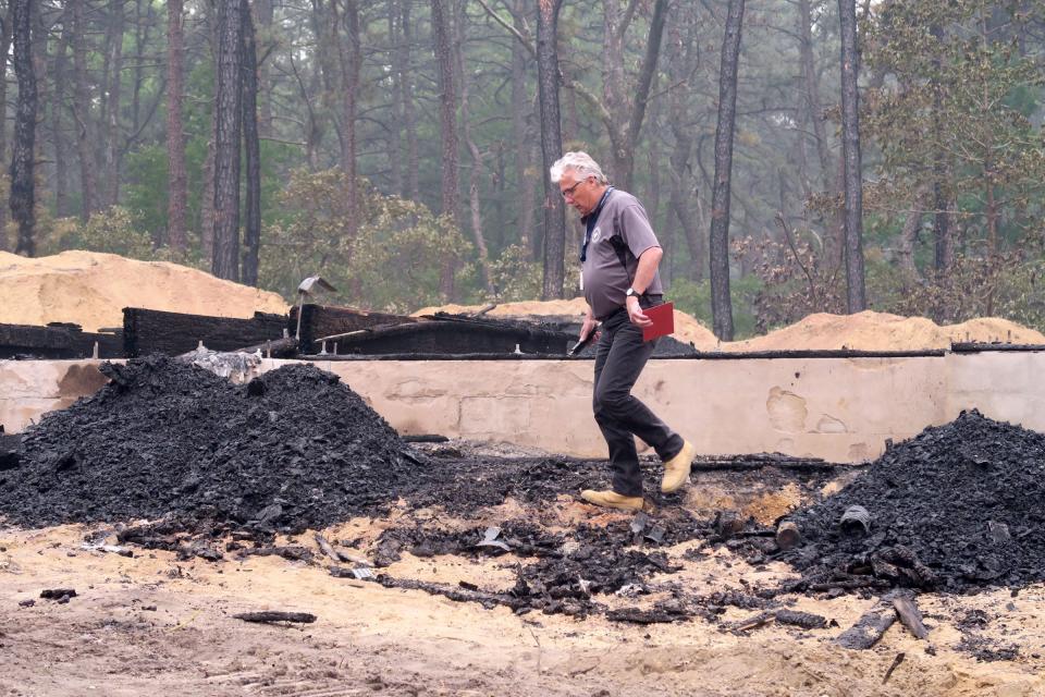 Gary Loftus from the Manchester Township Building Department walks amongst the rubble of a 1st Avenue home that was gutted by a suspicious fire Wednesday, Jun 7, 2023. 